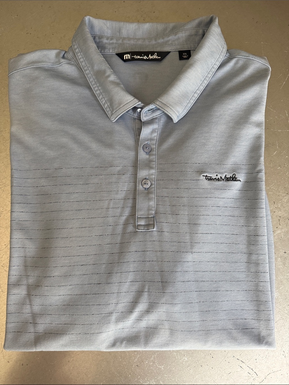 Travis Matthew Men’s Light Blue Golf Polo with subtle stripes